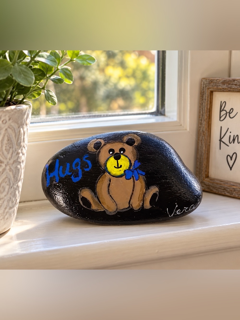 Hand crafted painted brown Teddy Bear rock sitting black stone blue bow HUGS